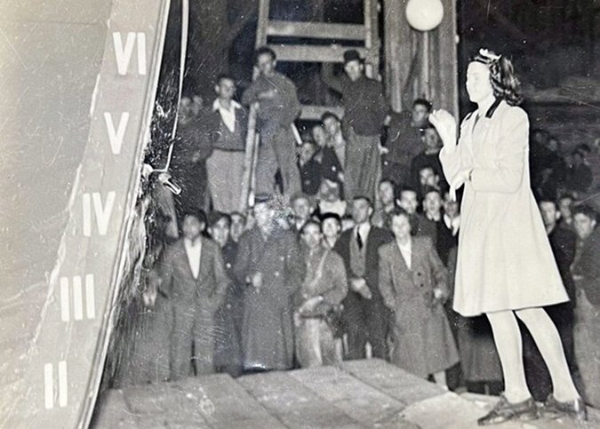 Jocelyn Skinner (age 14) christening an American WW2 support vessel at the boat’s official launching, watched by the Percy Vos staff and families. The boat was launched on the first high tide after completion, at 11pm on 13th July 1944.